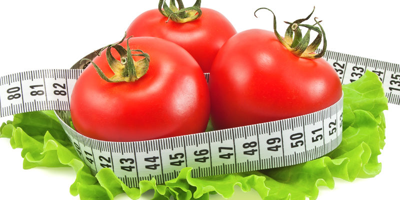 Tomatoes with tape measure and lettuce